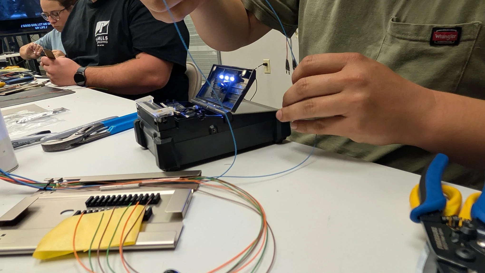 D&T Contractors technician fusion splicing fiber optic cable during hands-on training