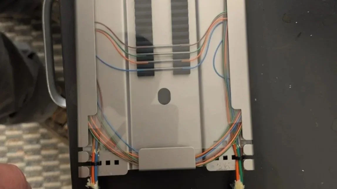 Completed fiber optic splice tray with dressed and routed fibers
