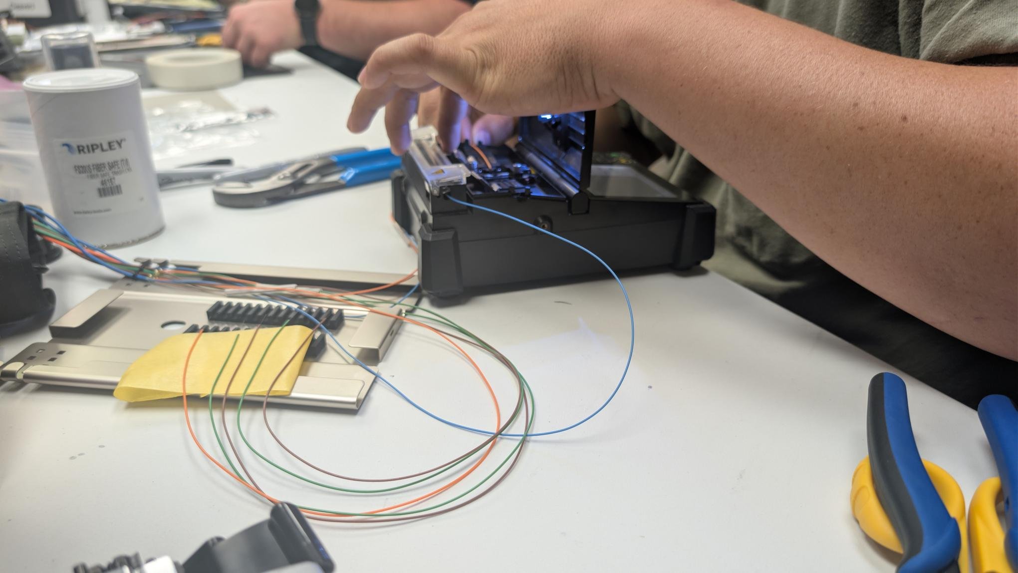 D&T Contractors technician fusion splicing fiber optic cable during hands-on training