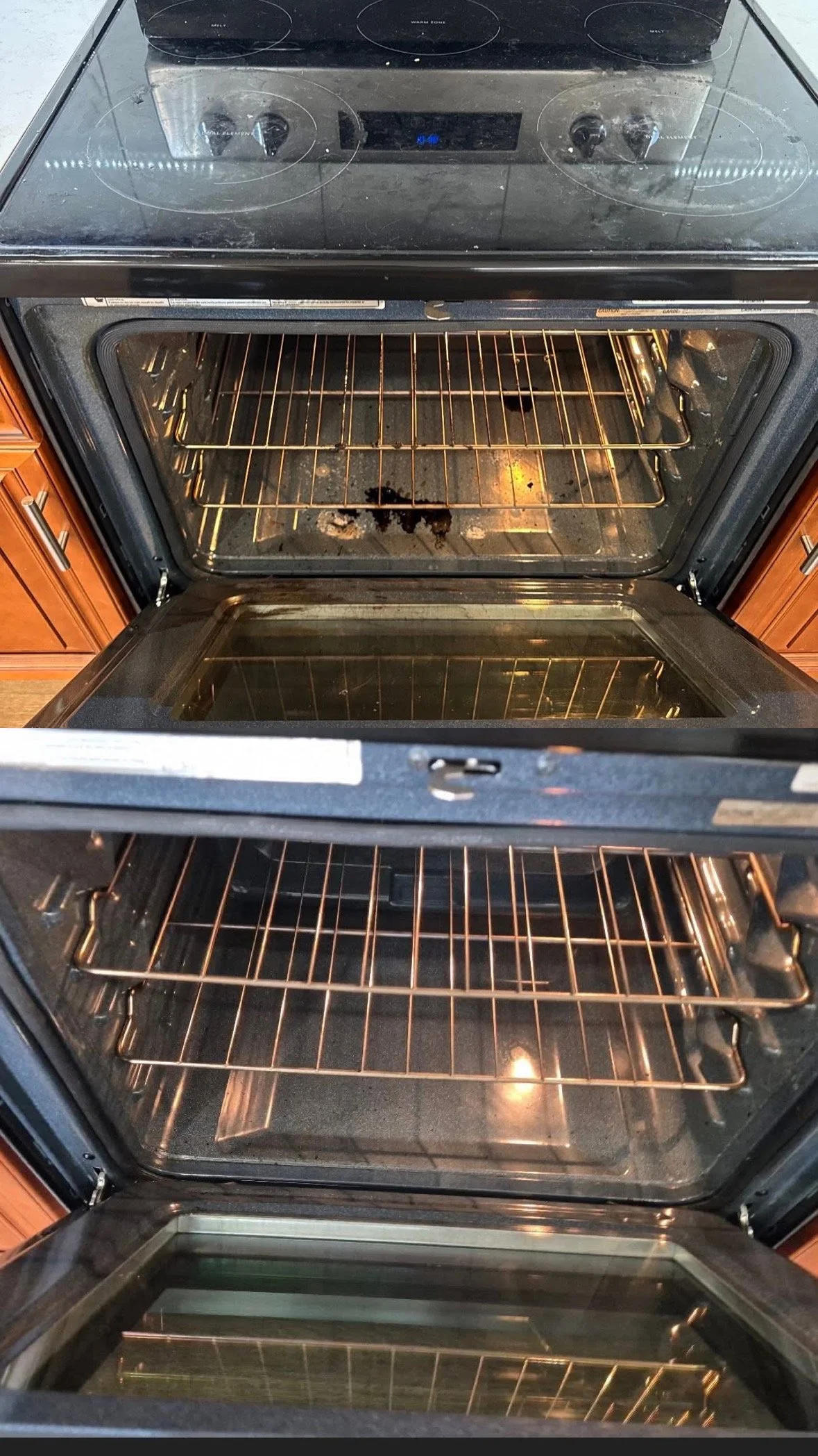 Inside view of an oven with its door open, showing two empty oven racks and the oven interior, which has some stains and residue.