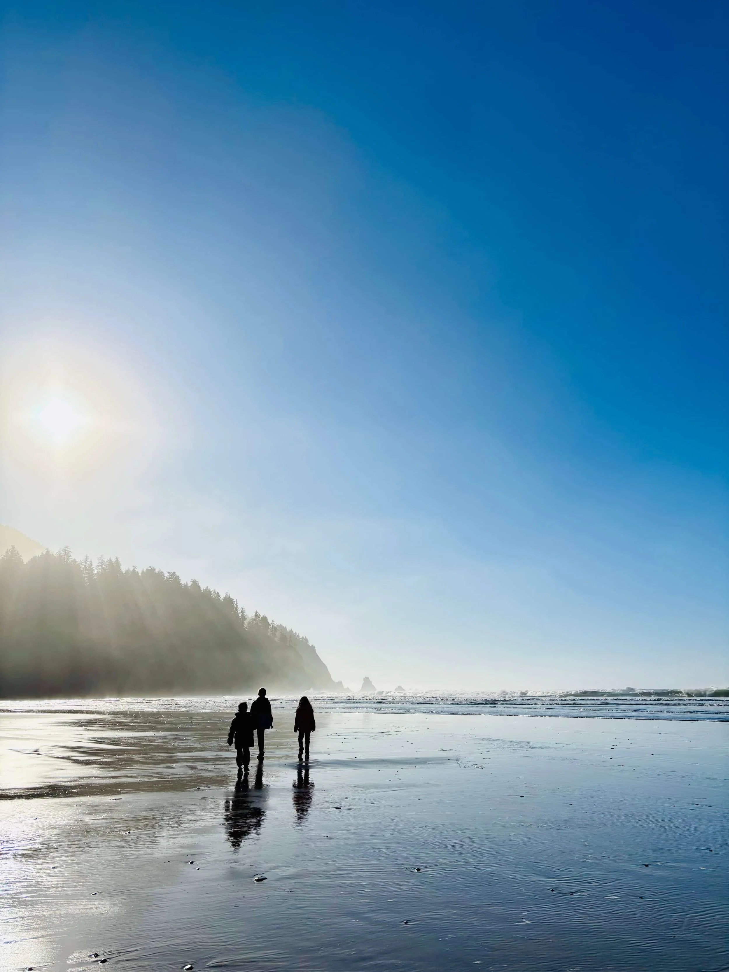 Claire and family walking on the beach in Oregon