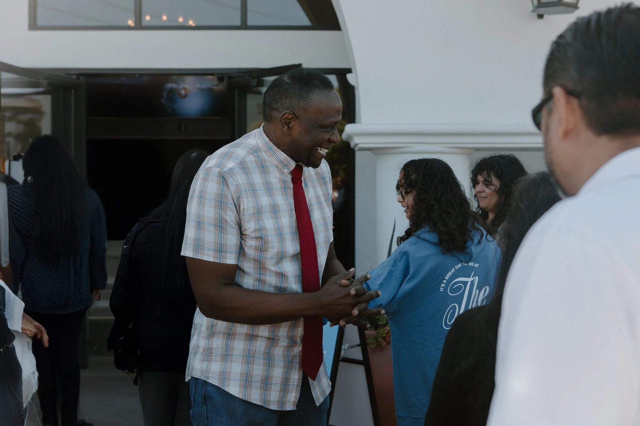 Pastor Ted mullins outside on the patio of the concord campus, engaging in diverse community