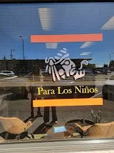Window display with a sign that says 'Para Los Niños' and a zebra pattern graphic.