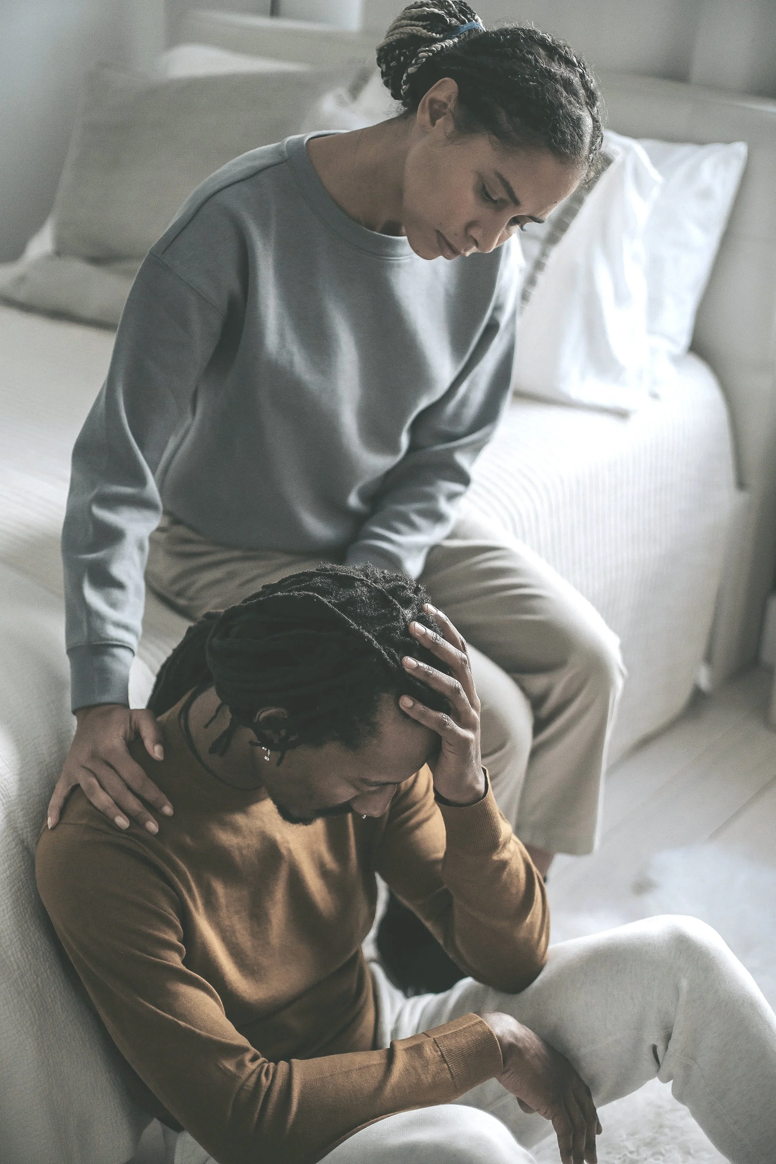 Two people in a tense but quiet moment of disconnection, reflecting the relational cost of needing to be right in relationships