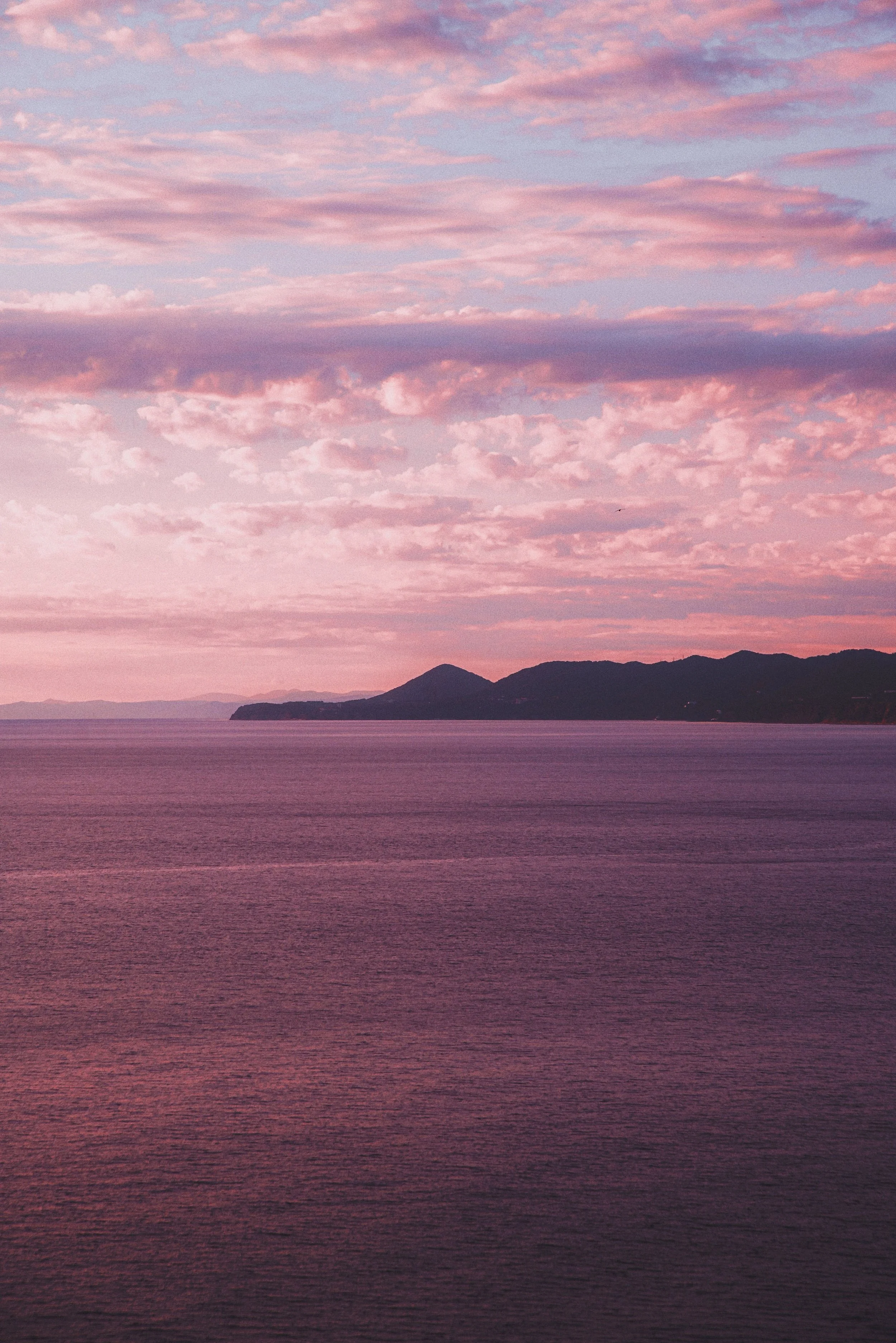 A vibrant pink, orange, and purple sunset sky, symbolizing the possibility of integration, peace, and wholeness after trauma healing through EMDR