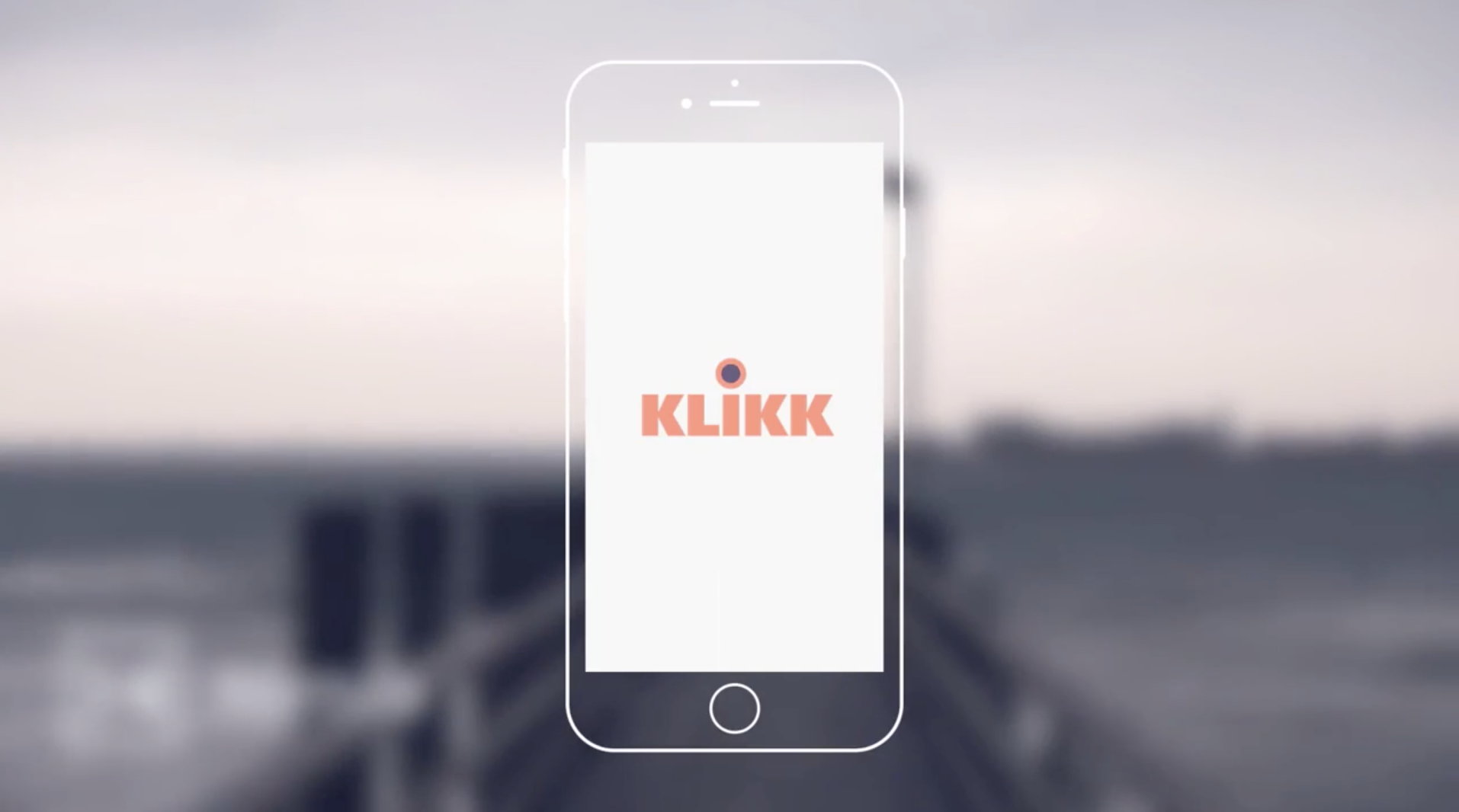 A mockup of a smartphone with the logo 'KLIKK' on the screen, superimposed on a blurred outdoor background.
