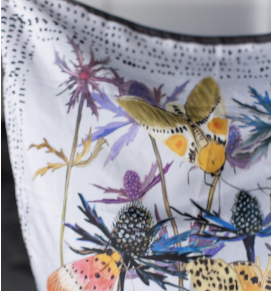 moths, Square silk scarf with bright pink and red floral illustration on a soft background, designed by Briana Corr Scott and printed in Montreal, Canada.