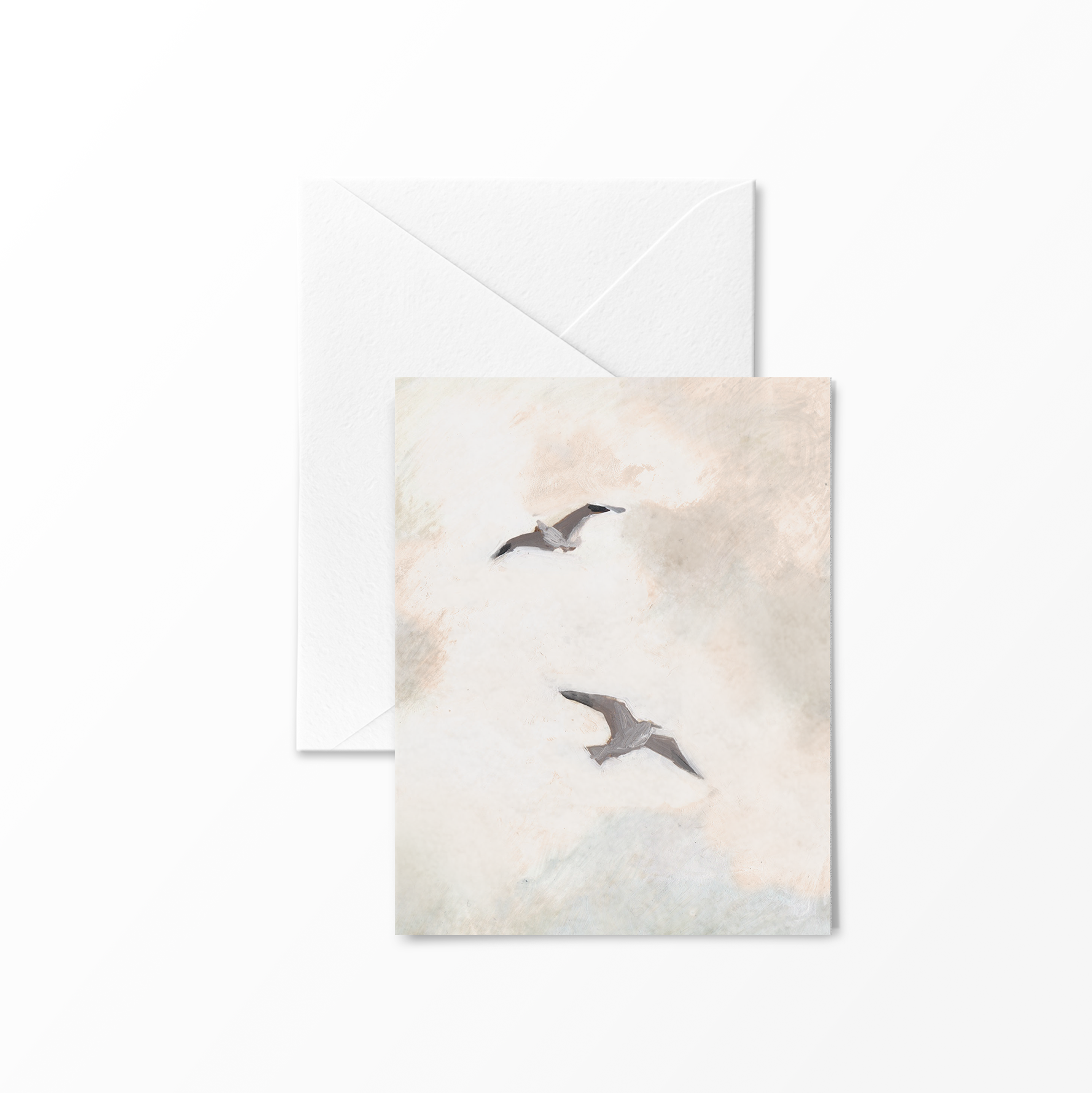 Greeting card featuring two seagulls flying through a soft, painterly coastal sky in muted tones – folded A2 card illustrated by Briana Corr Scott