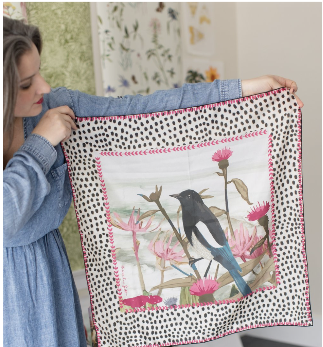 Square silk scarf with bright pink and red floral illustration on a soft background, designed by Briana Corr Scott and printed in Montreal, Canada.