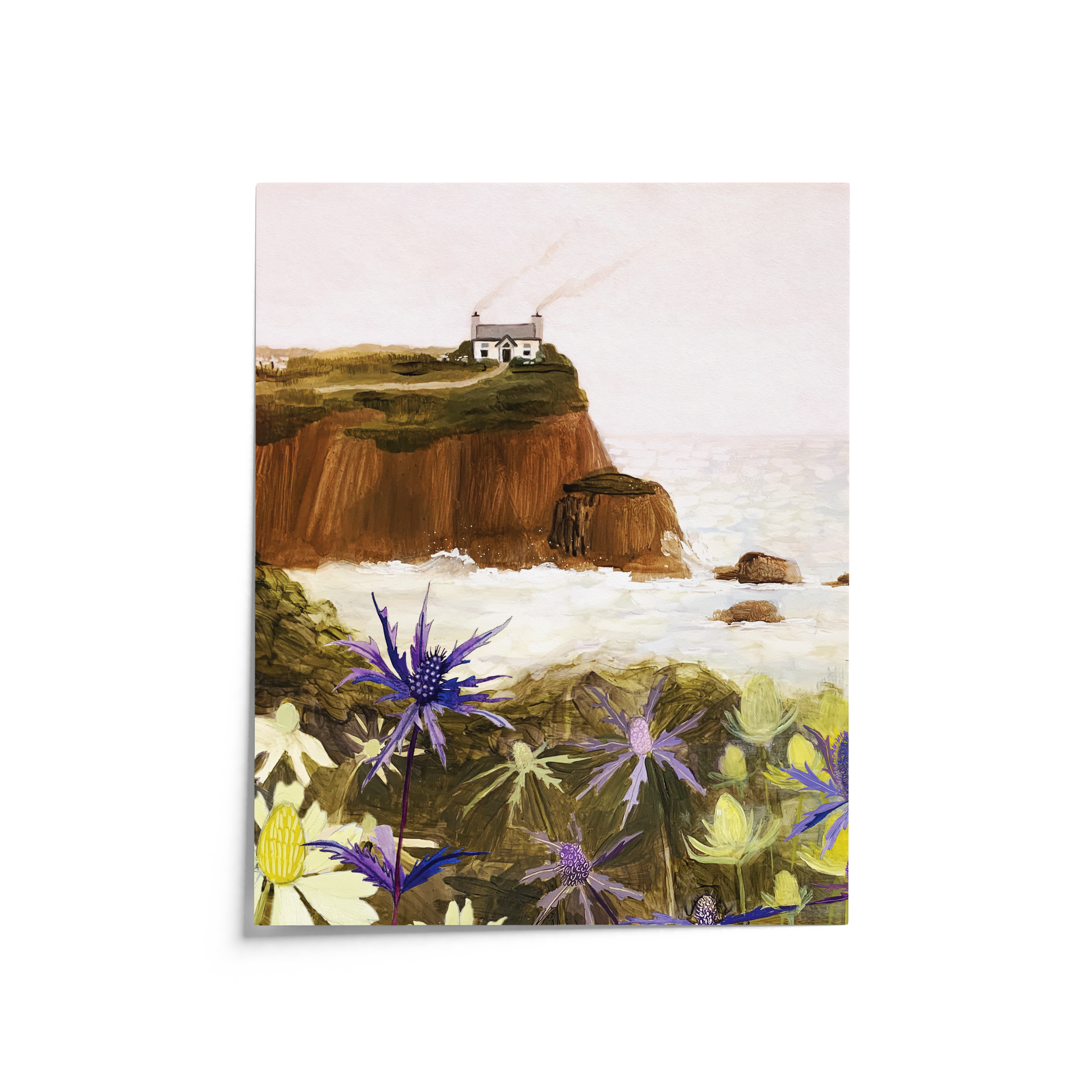 Gouache painting of a coastal cliff with a white house, sea holly flowers in the foreground, and waves crashing below – artwork by Briana Corr Scott