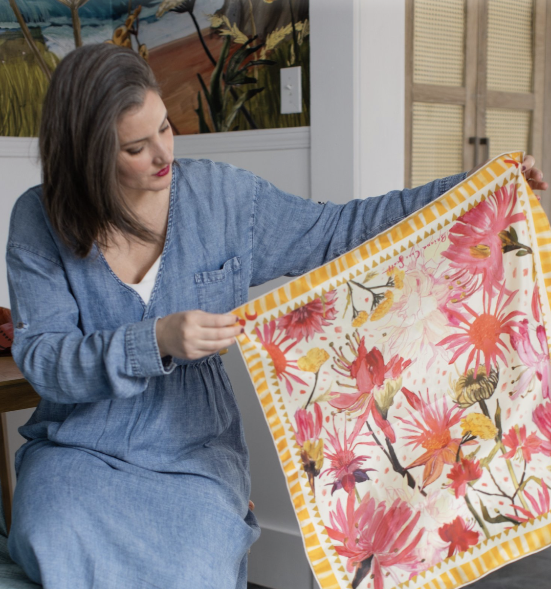 Square silk scarf with bright pink and red floral illustration on a soft background, designed by Briana Corr Scott and printed in Montreal, Canada.