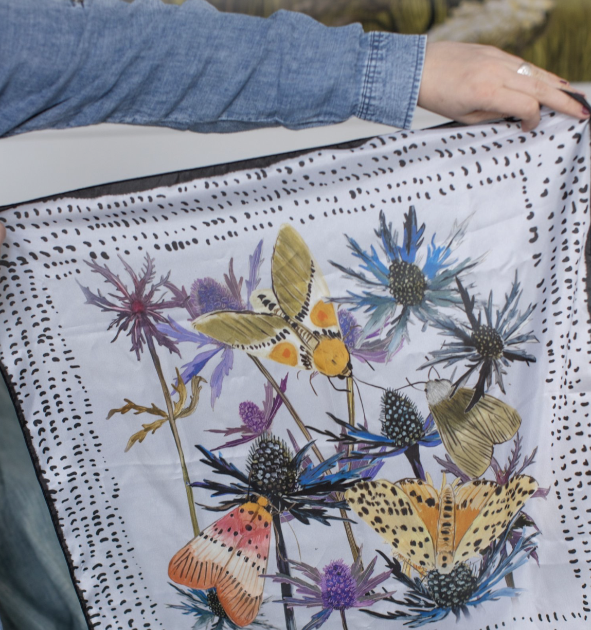 moths, Square silk scarf with bright pink and red floral illustration on a soft background, designed by Briana Corr Scott and printed in Montreal, Canada.