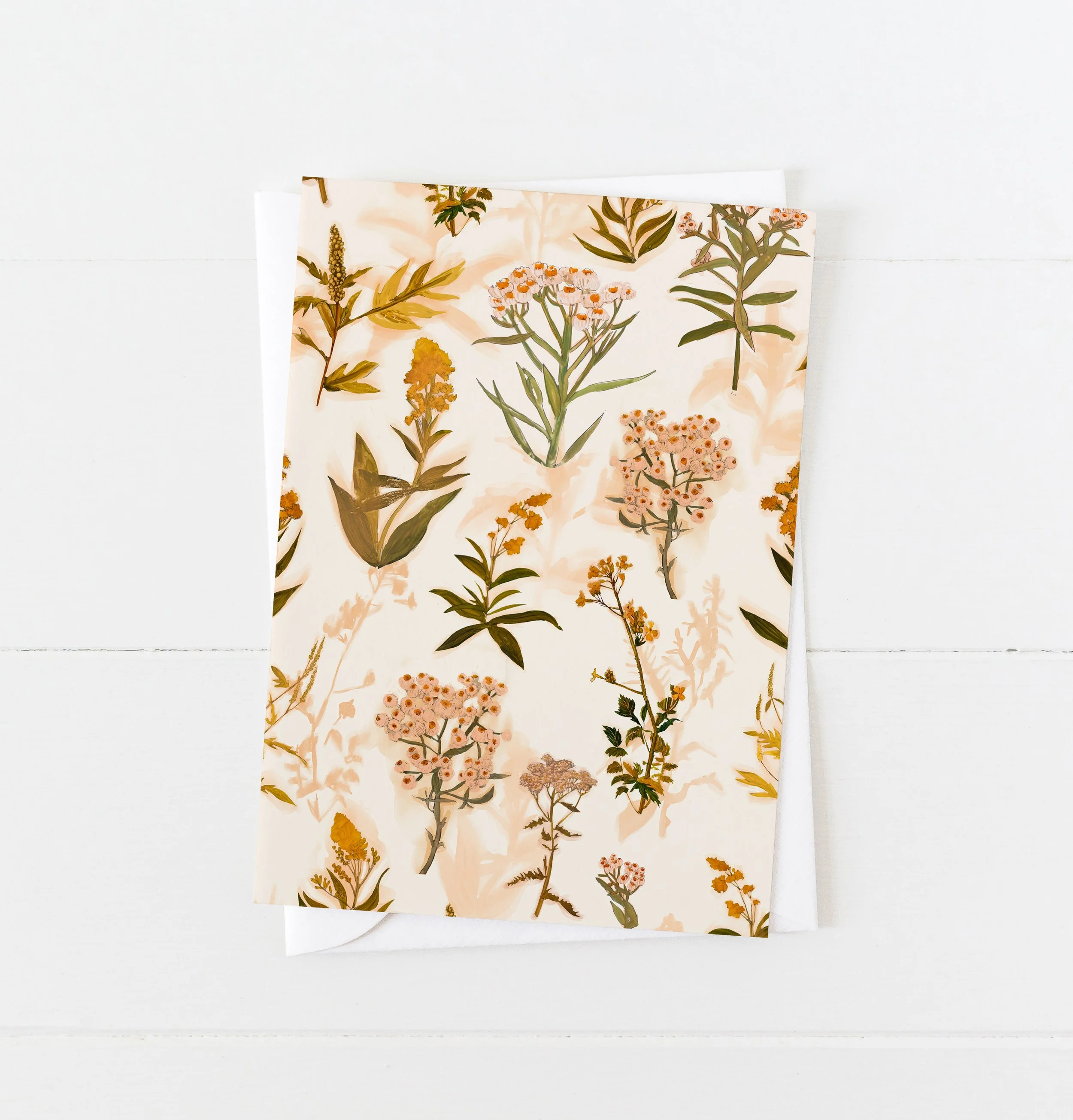 Greeting card with a repeating pattern of Sable Island wildflowers in soft ochre, peach, and gold tones on a cream background – artwork by Briana Corr Scott