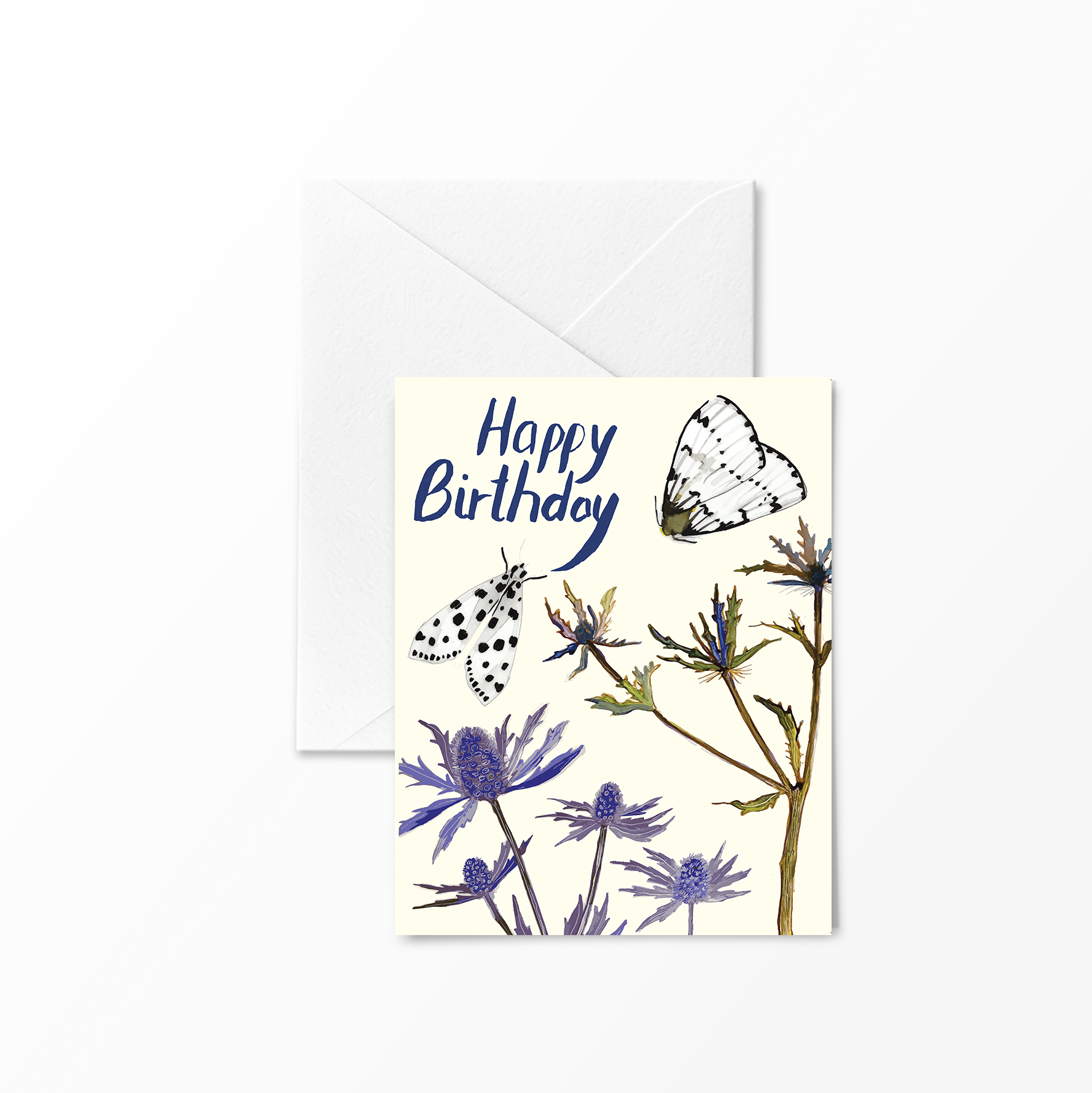 Greeting card with “Happy Birthday” hand-lettered in blue at the top, featuring two black-and-white moths and purple thistle-like flowers against a cream background.