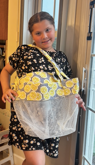 girl showing off a beach tote bag