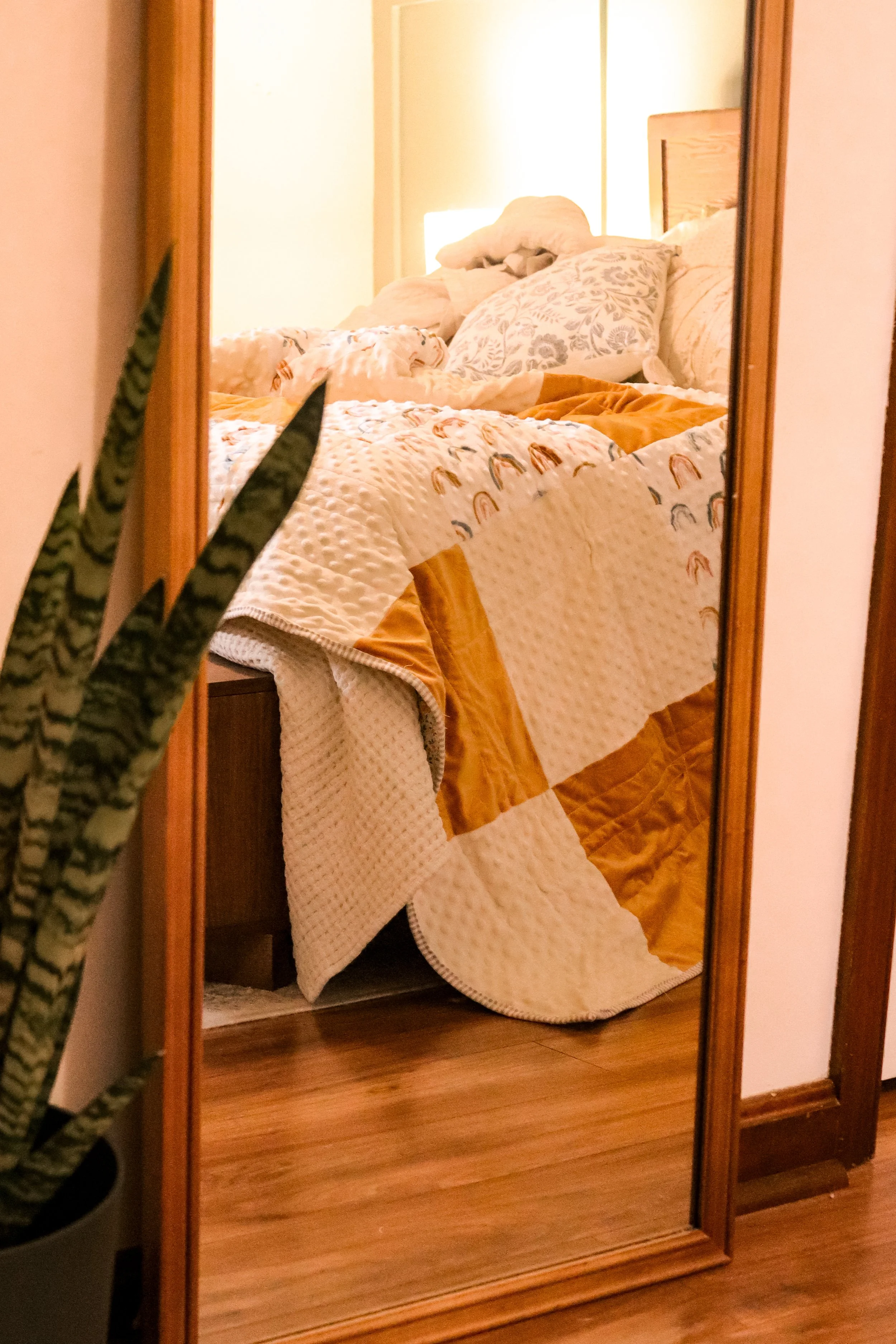 warm yellow quilt over edge of bed