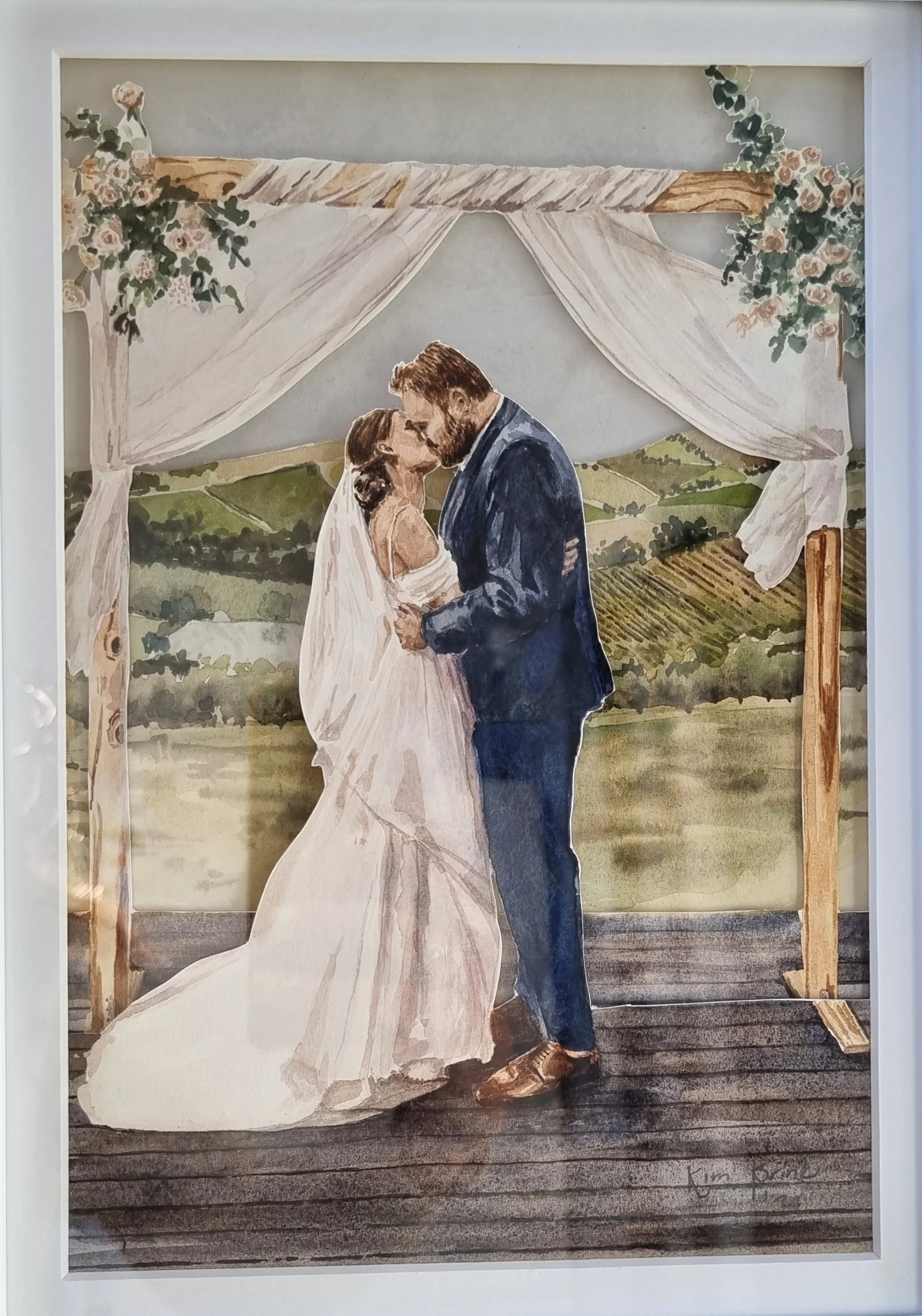 A layered watercolour shadowbox, of a couple having their first kiss at their wedding, in the Stellenbosch Winelands.