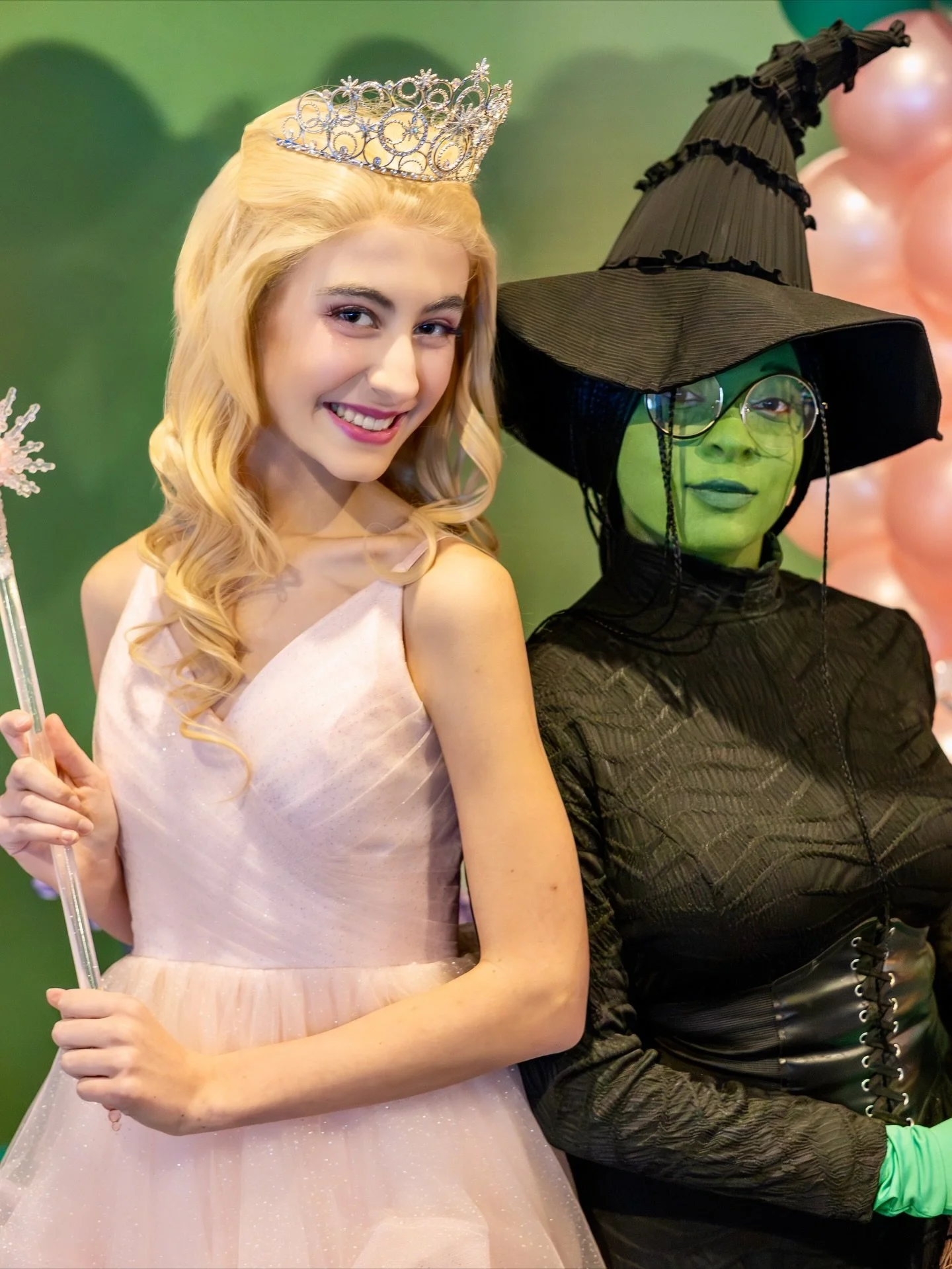 Two women dressed as Glinda and the Wicked Witch from the Wizard of Oz.