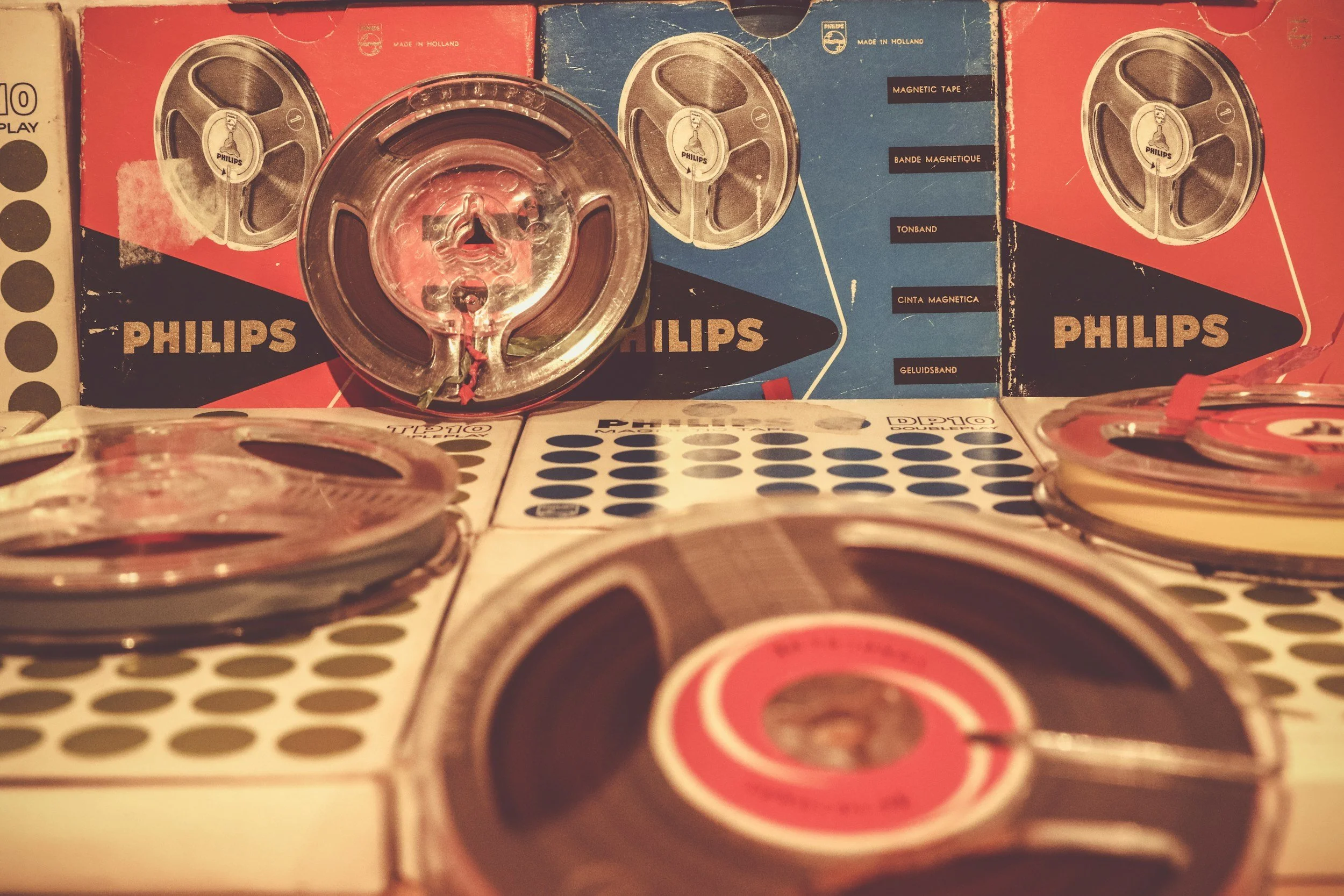 Several vintage Philips audio cassette tapes and their boxes, with some tapes in transparent cases stacked in the foreground.