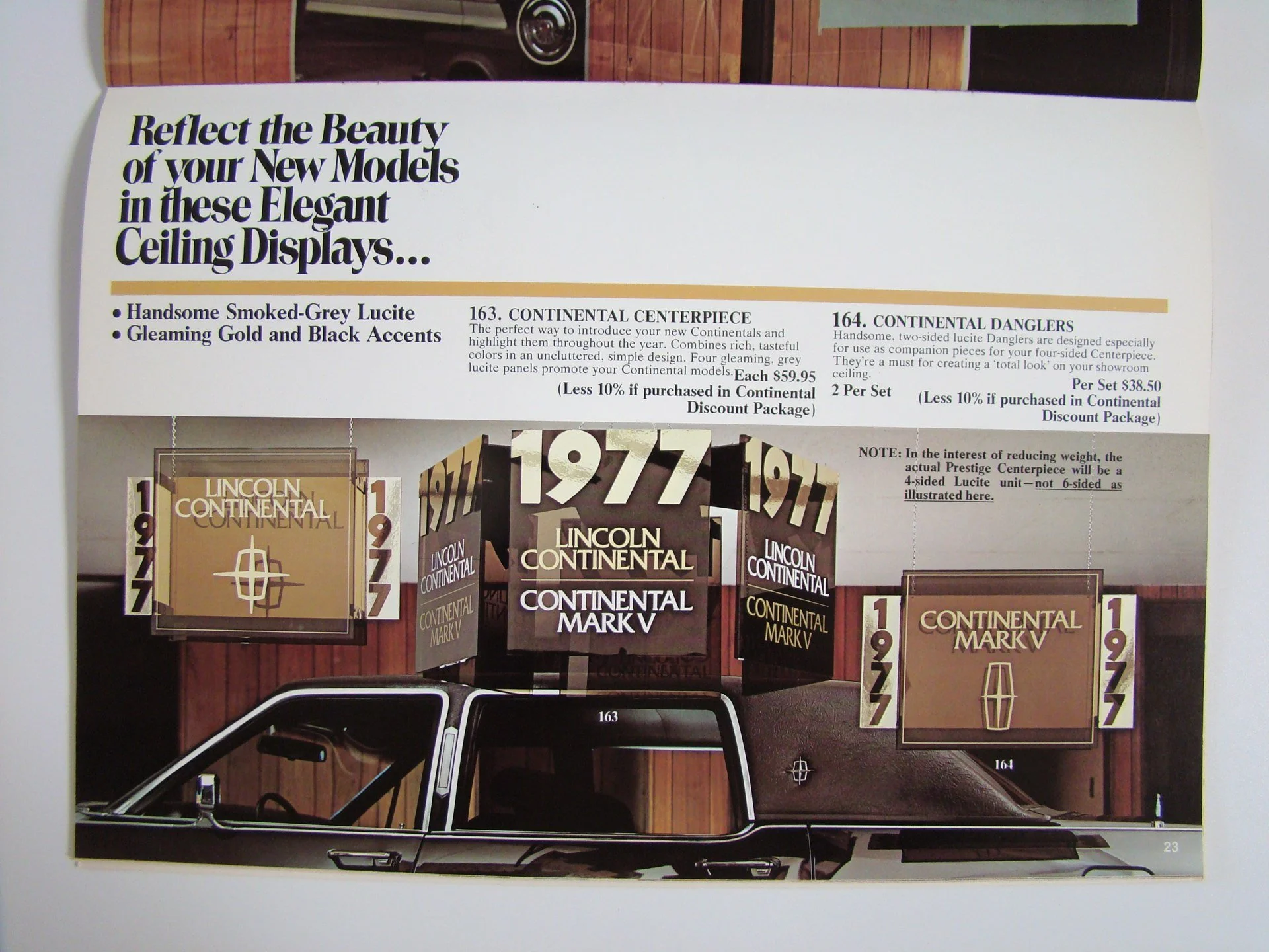 Catalog page showing Lincoln Continental ceiling display models with black and gold accents, including some 1977-themed display booths and a photo of a black car at the bottom.