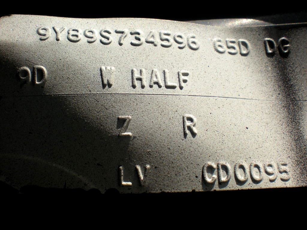 Close-up of a metallic surface with engraved serial numbers and letters, including the text '9Y8395734596', 'ESD', 'DC', '9D', 'W HALF', 'Z', 'R', 'L V', and 'CD0095'.