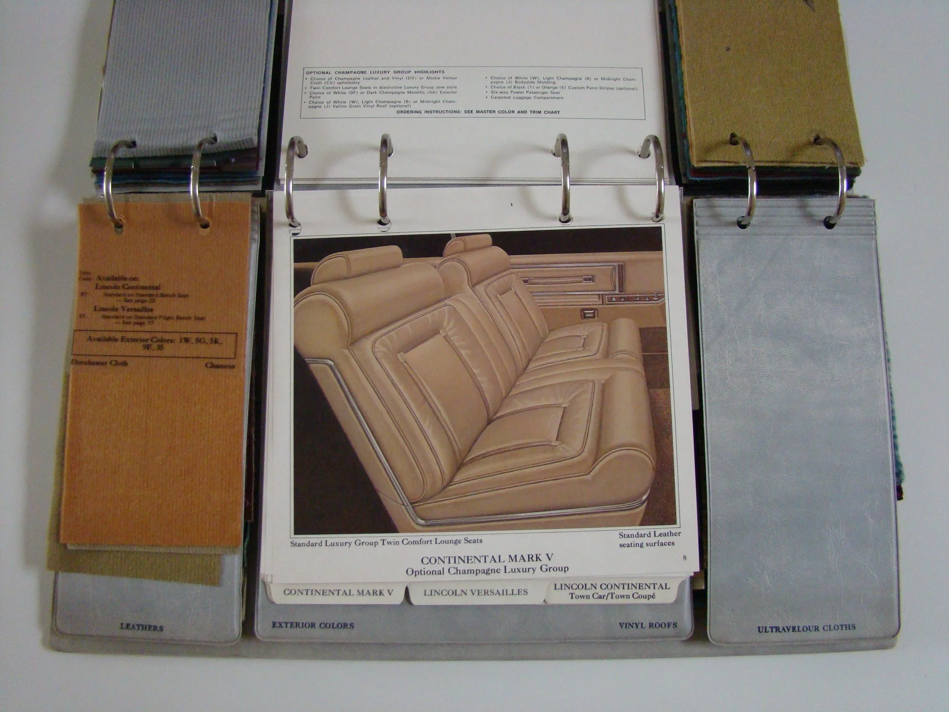 Sample car interior and upholstery material swatches for luxury vehicle. Includes color options and leather samples.