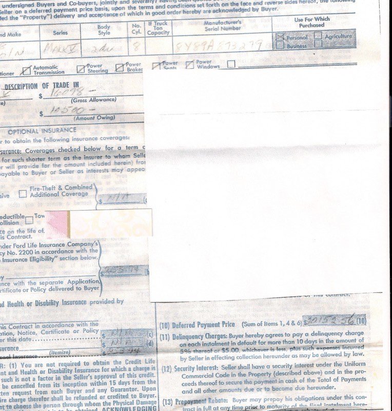 Close-up of a blank vehicle registration or transfer form with sections for vehicle details, buyer and seller information, and insurance, but mostly empty.