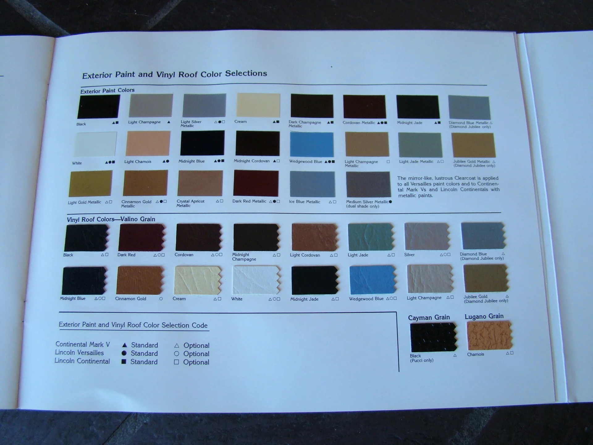 Page from a catalog showing exterior paint and vinyl roof color options, including paint colors like black, white, and various metallic shades, along with vinyl roof colors such as black, red, and cream.