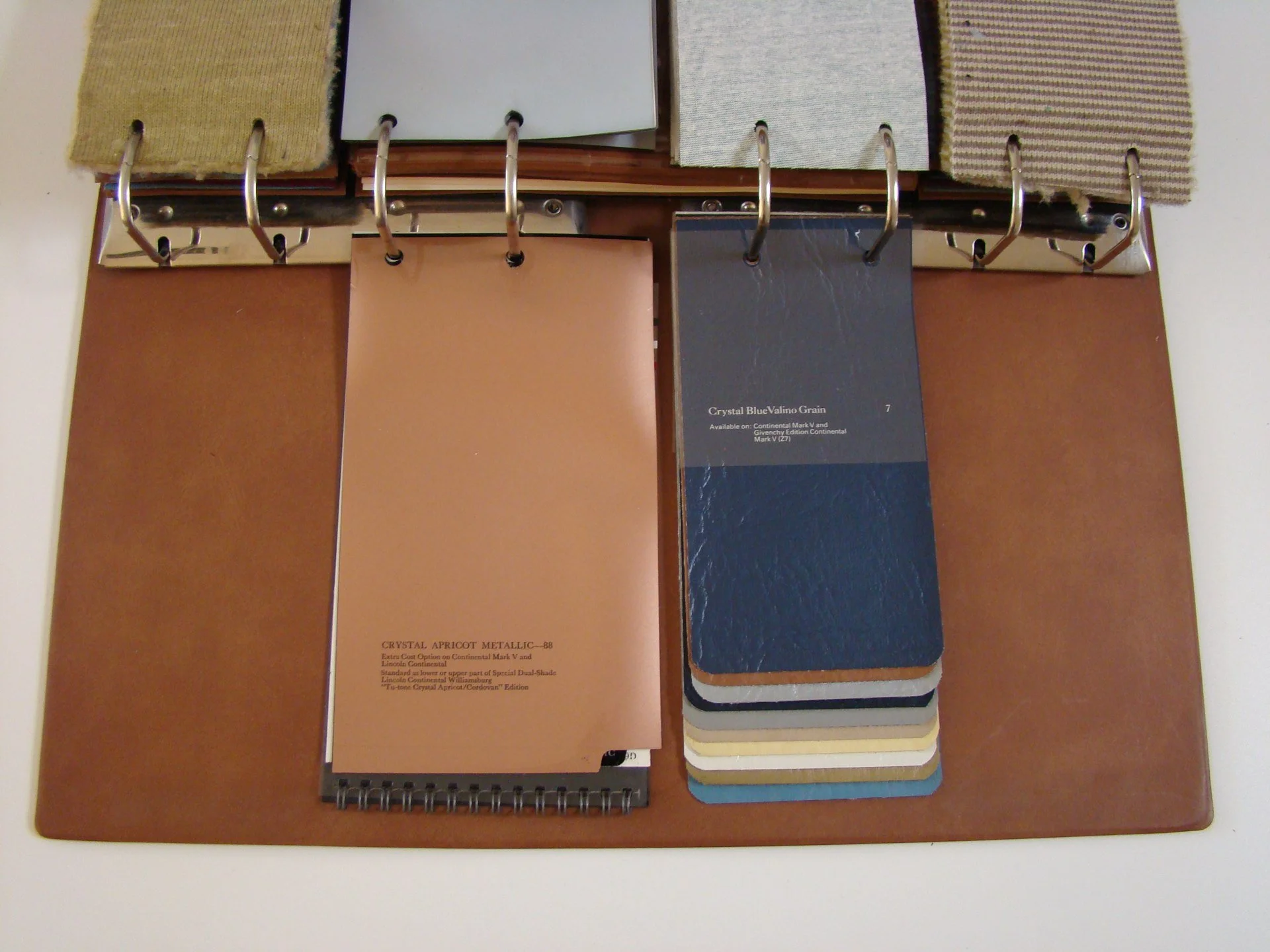 Sample book and fabric swatches on a color sample display board.