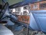 Interior of a vehicle, showing the dashboard, steering wheel, and front seats.