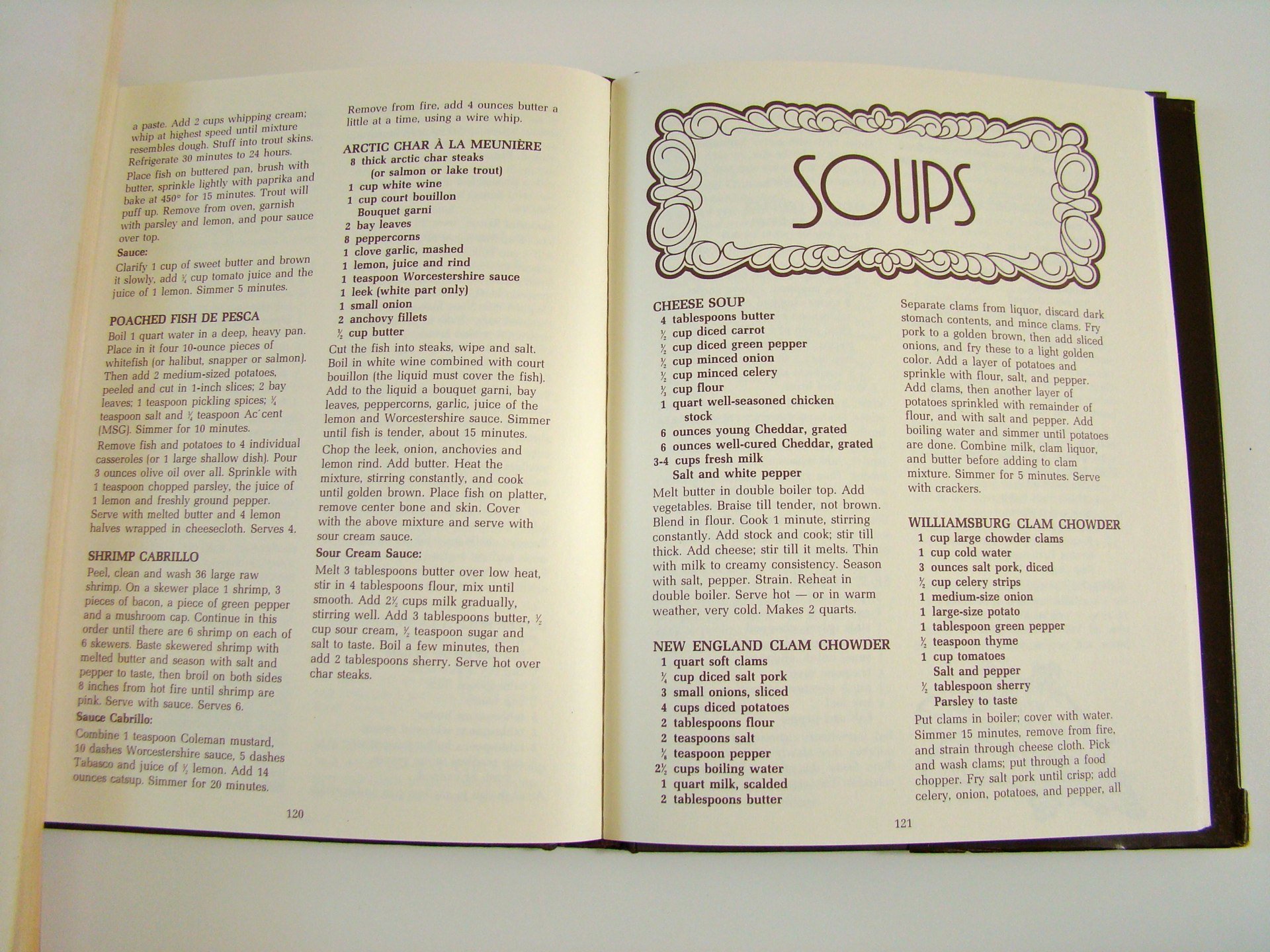 Open cookbook showing pages with recipes for soups, including cheese soup, clam chowder, and crab chowder.