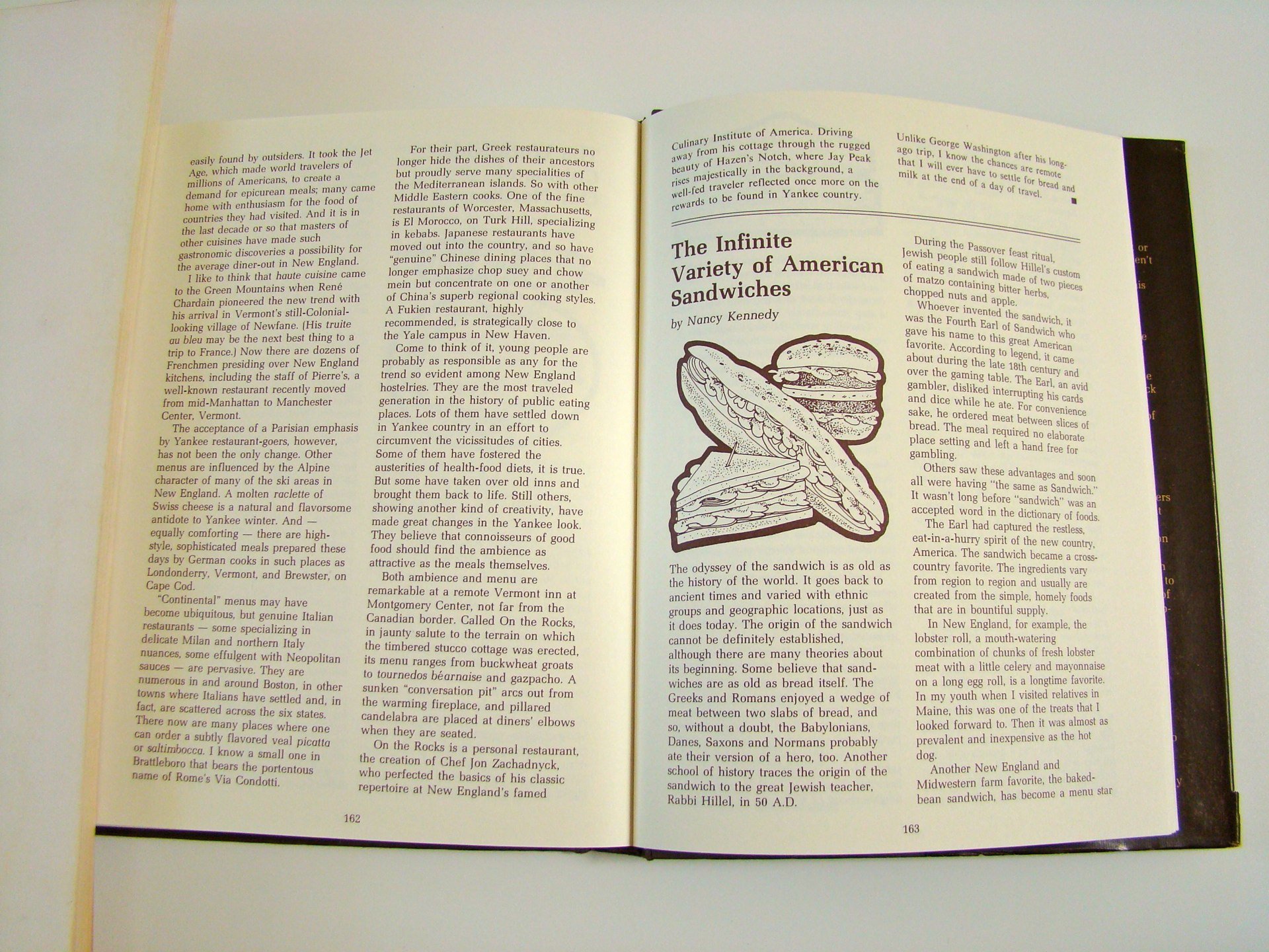 Open book displaying pages with text about American sandwiches, including a black and white illustration of a sandwich with lettuce, meat, and bread.