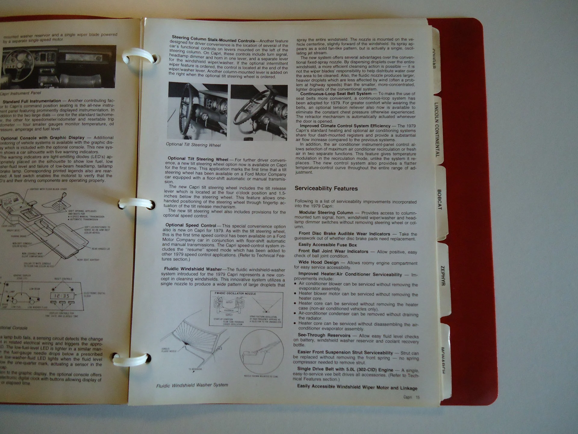 Open car owner’s manual showing car features and controls including steering options, dashboard, windshield washer system, and serviceability features.