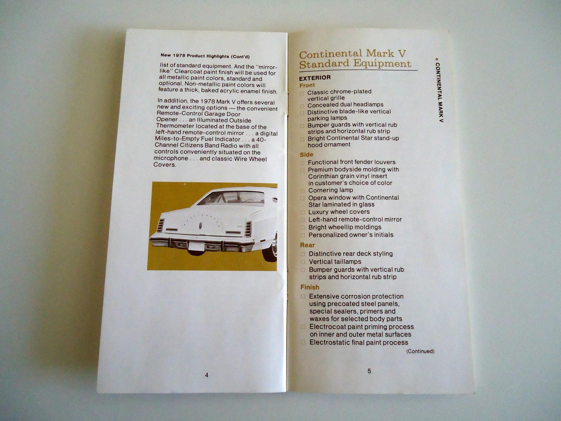 Open car brochure with a photo of a 1978 Continental Mark V showing exterior features and a list of standard equipment.