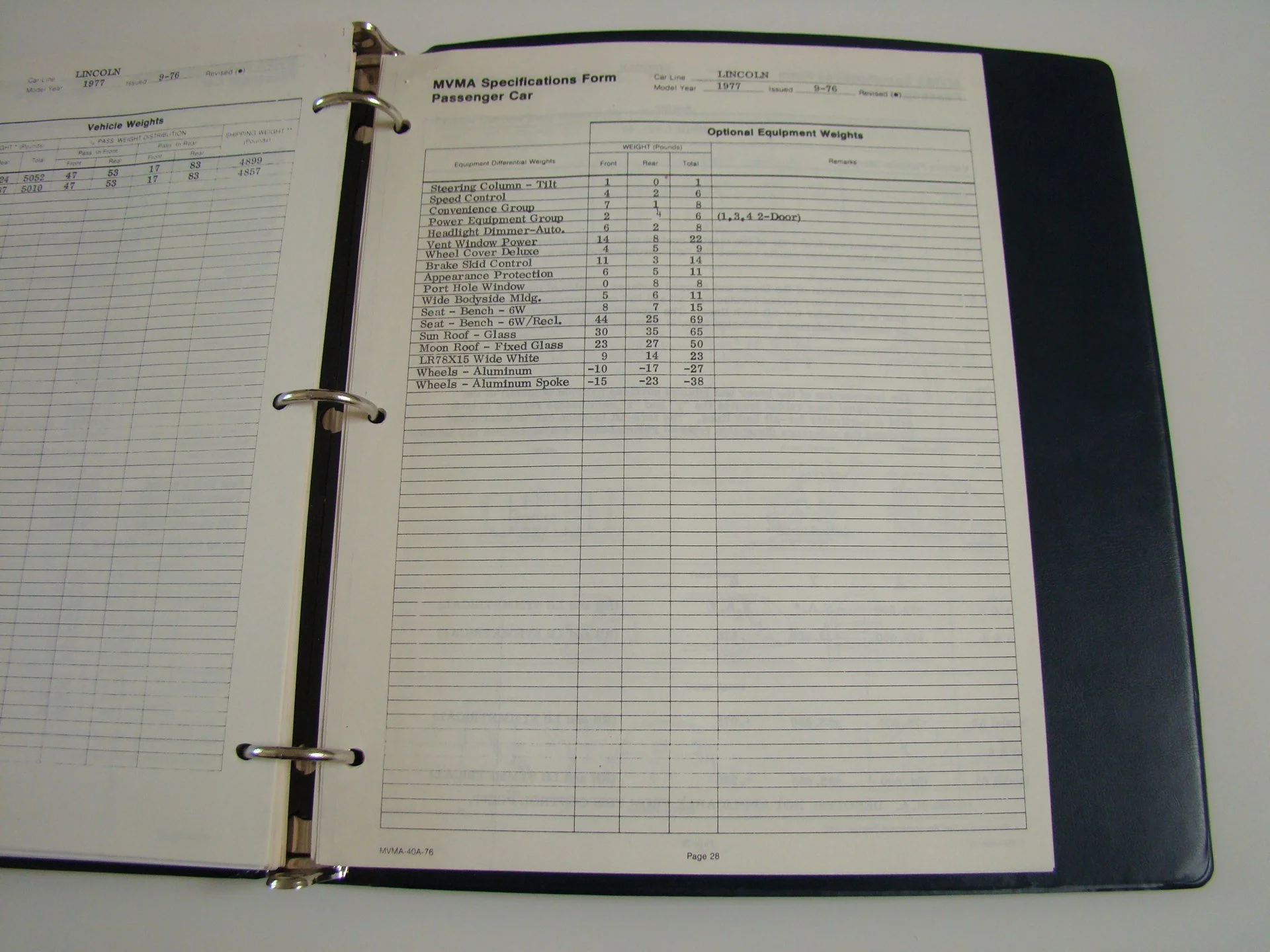 Open vehicle specifications binder page with details for a 1977 Lincoln passenger car, including optional equipment weights like steering column tilt, speed control, and wheel weights.