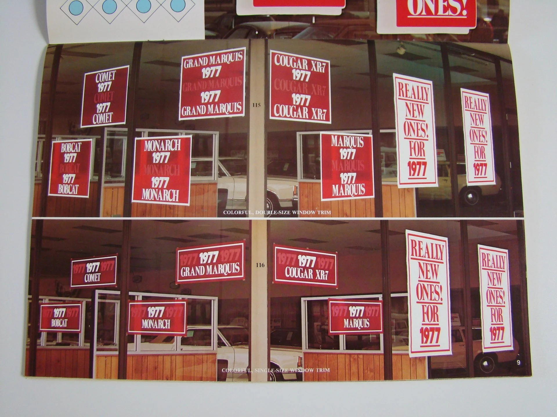 Photo of multiple campaign posters for cars from 1977, including models such as Comet, Bobcat, Monarch, Grand Marquis, Cougar XR7, and Marquis, displayed in a window. The posters feature red and white colors with bold text.