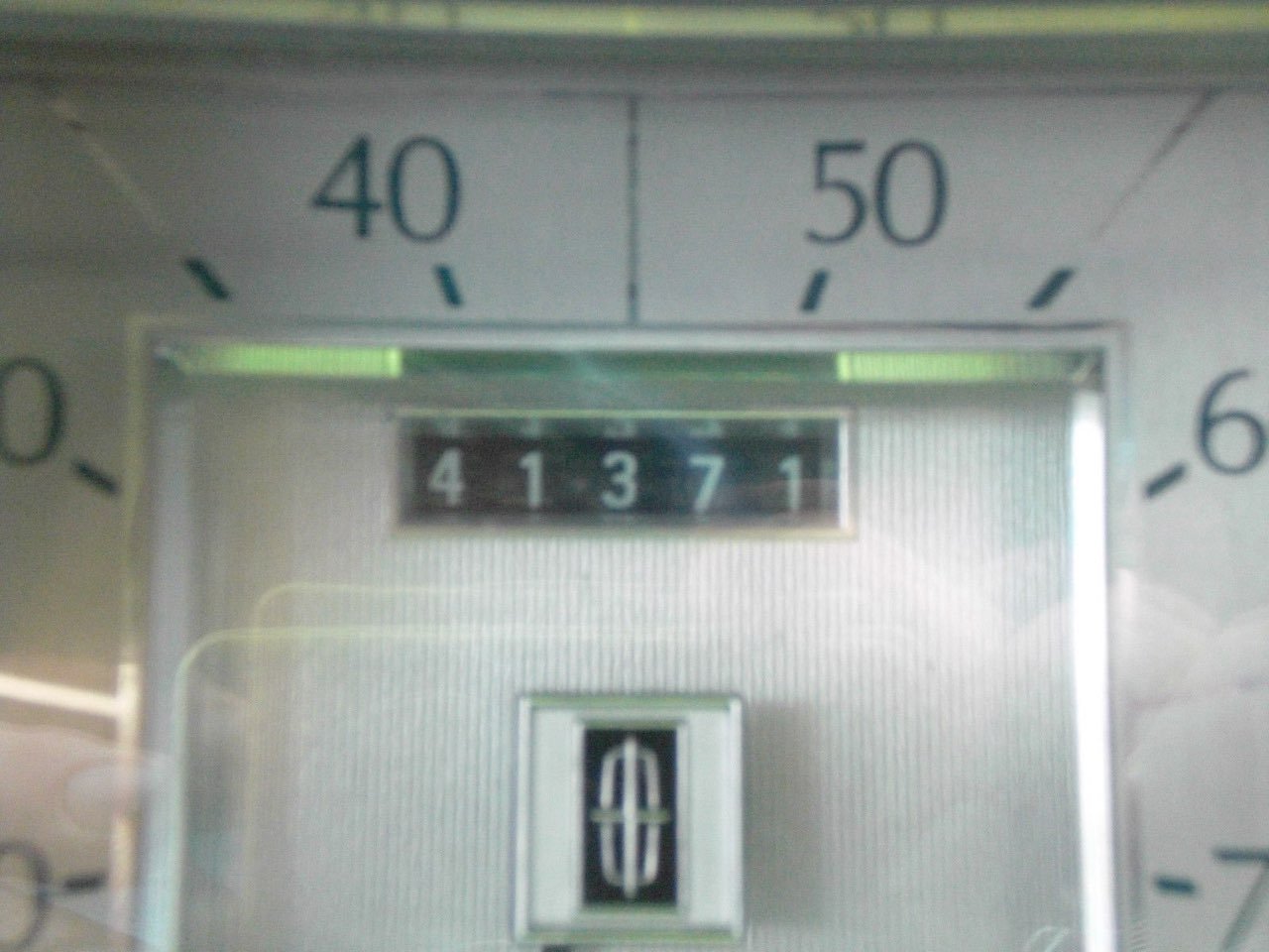 Close-up of a digital lock keypad with the numbers 4, 1, 3, 7, 1 displayed, surrounded by a background with hour markings from 0 to 6 and a partially visible circular dial.