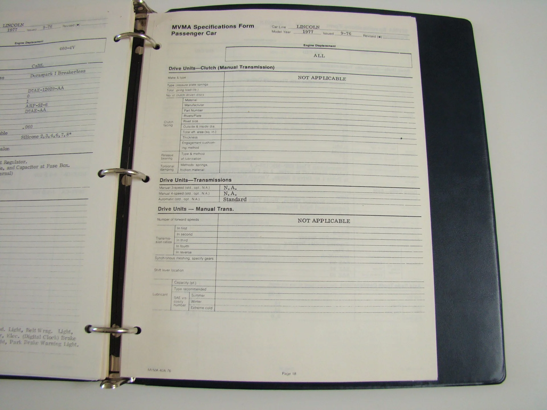Open binder holding a vehicle specifications form labeled 'MVMA Specifications Form Passenger Car' for a 1977 Lincoln. The form includes sections for engine displacement, drive units, transmissions, and manual transmission details.
