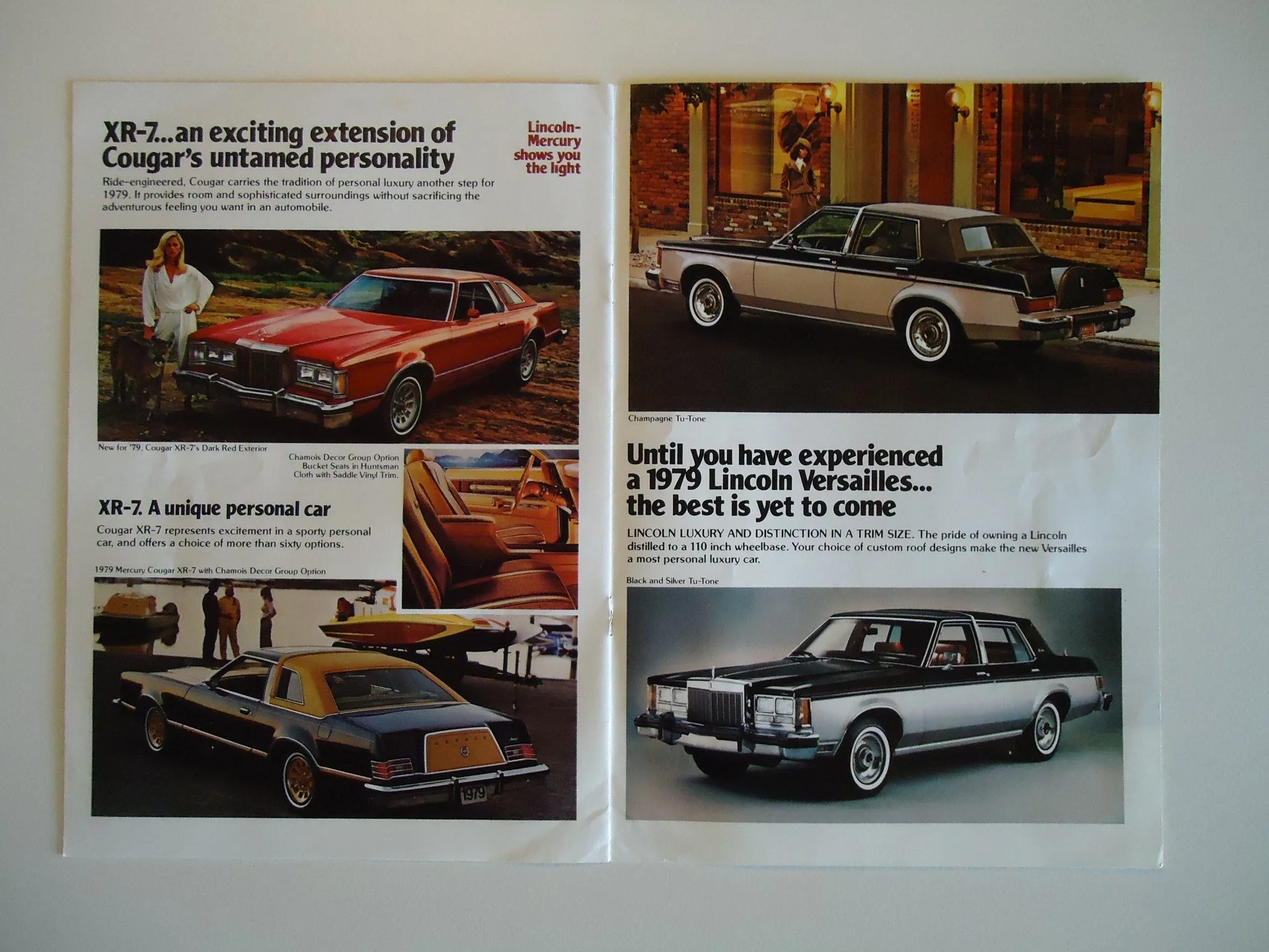 An open magazine spread showcasing vintage Lincoln and Mercury cars from the 1970s, with images and descriptions of specific models including the 1979 Cougar XR-7 and Lincoln Versailles.