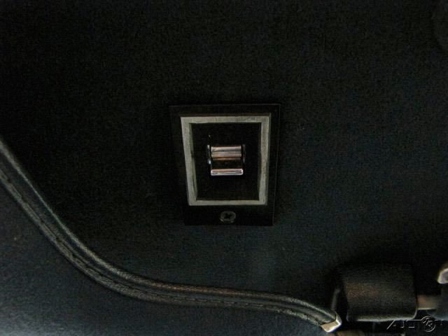 Close-up of an Ethernet port embedded in a black surface, likely inside a vehicle or electronic device.