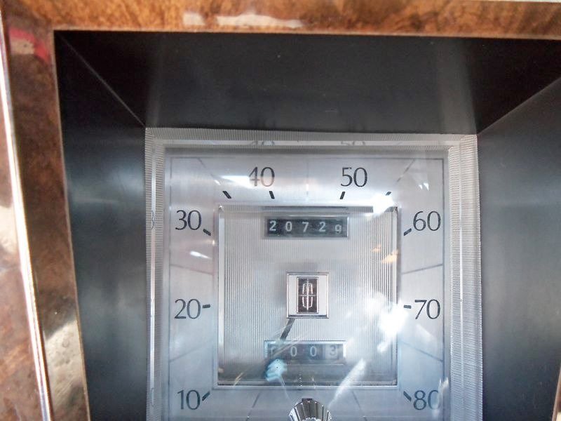 Close-up of a vintage speedometer with an odometer reading 20,720 miles.