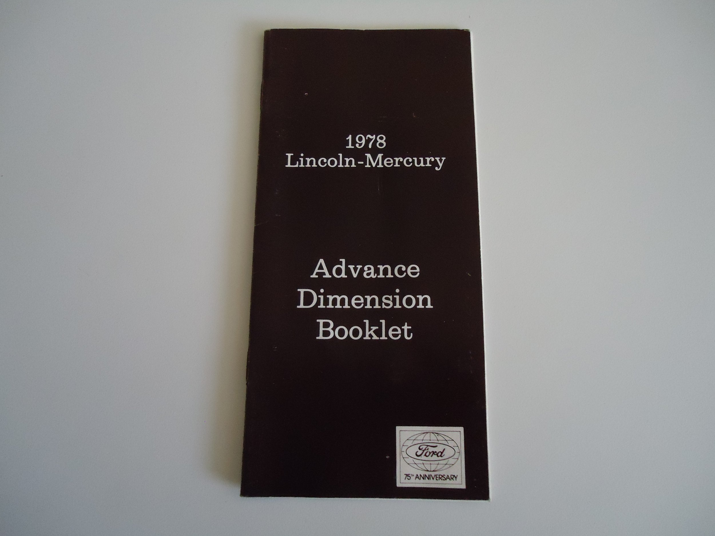 Black booklet titled '1978 Lincoln-Mercury Advance Dimension Booklet' with a Ford 75th Anniversary logo at the bottom.