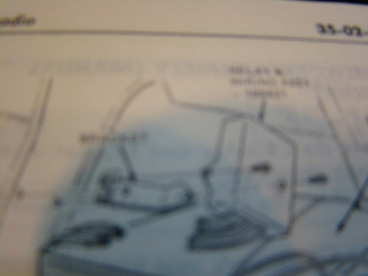 A blurry blueprint or schematic drawing with lines and labels.
