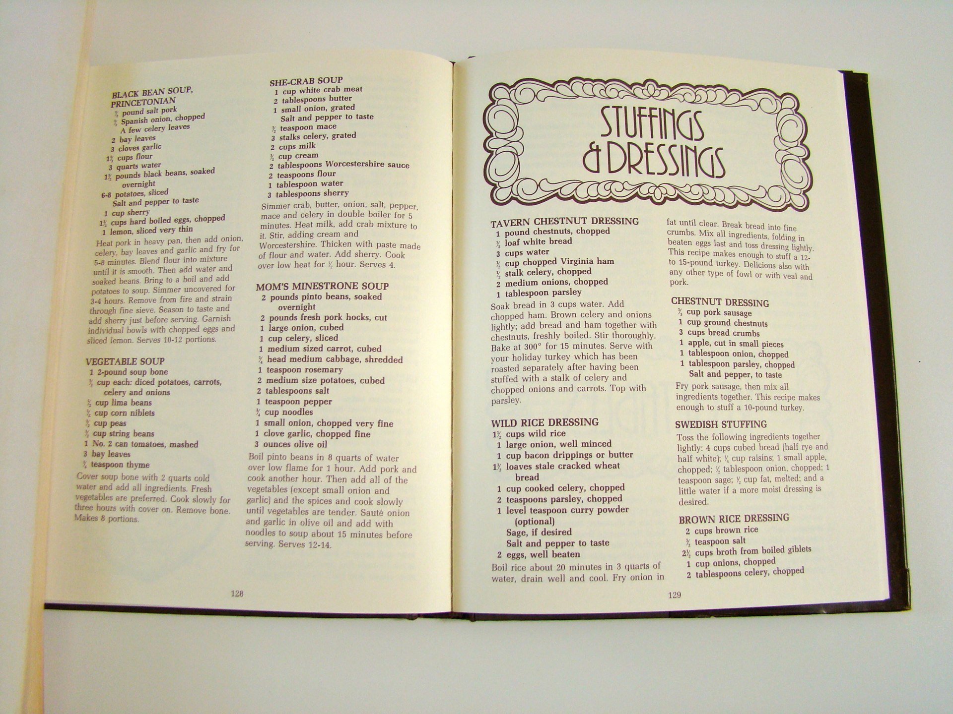 Open cookbook showing recipes for soups, dressings, and stuffings on pages 128 and 129.