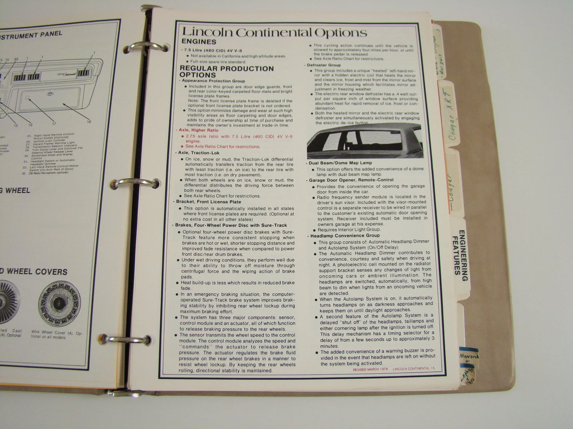 Open binder with car maintenance manual pages showing information about Lincoln Continental engine options, production features, and accessories, with visible tabs on the side.