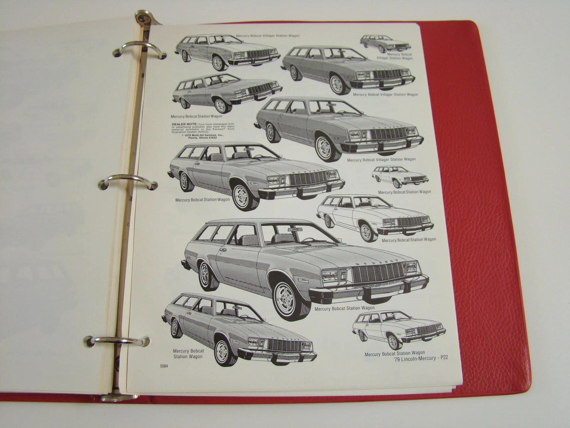 Black and white illustrations of various Mercury Bobcat Station Wagons and Sedans, with labels describing each model, inside a red binder with metal rings.
