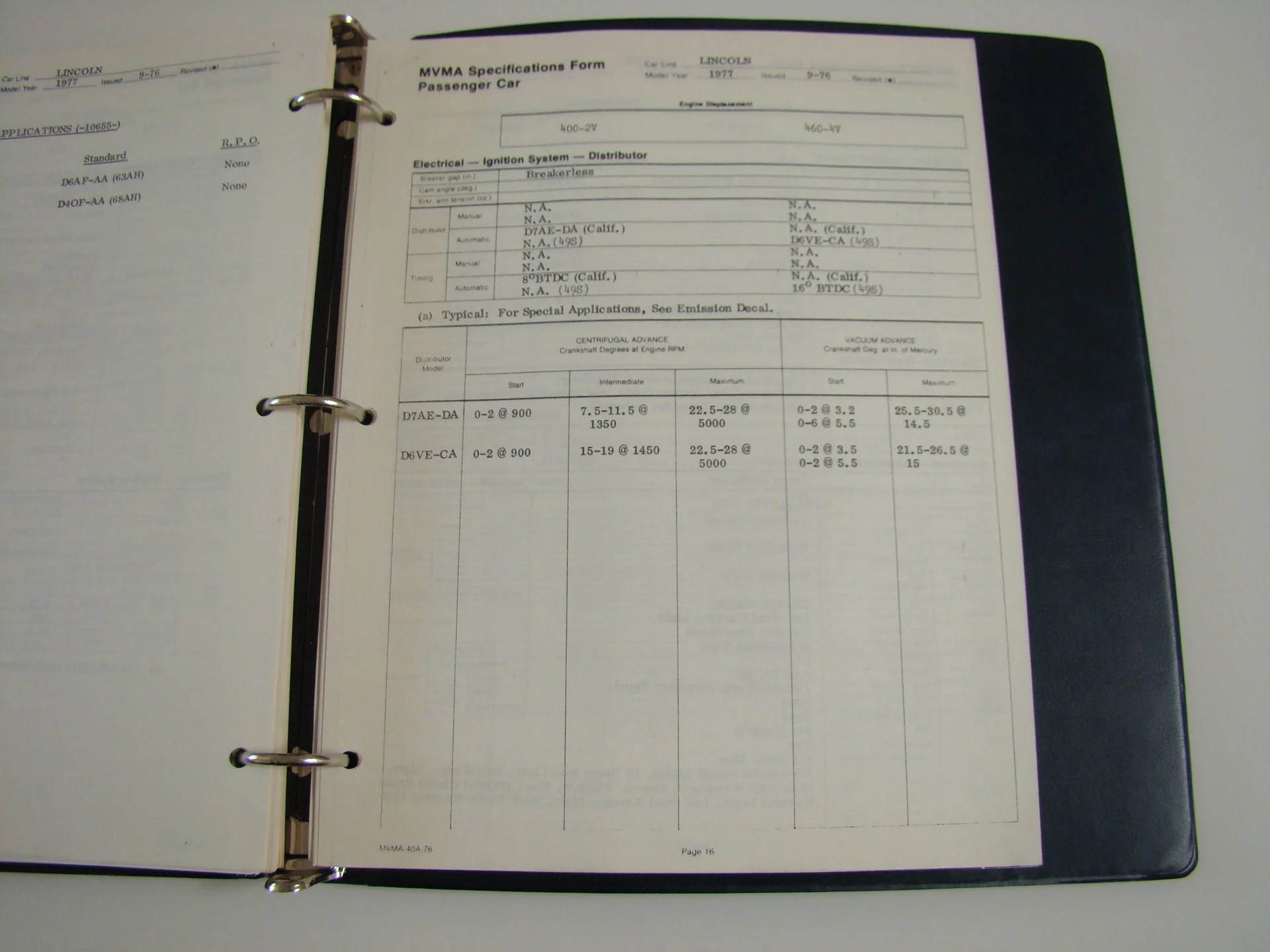 Open binder with MVMA specifications form for a 1977 Lincoln passenger car on the right, and a blurred document on the left page.