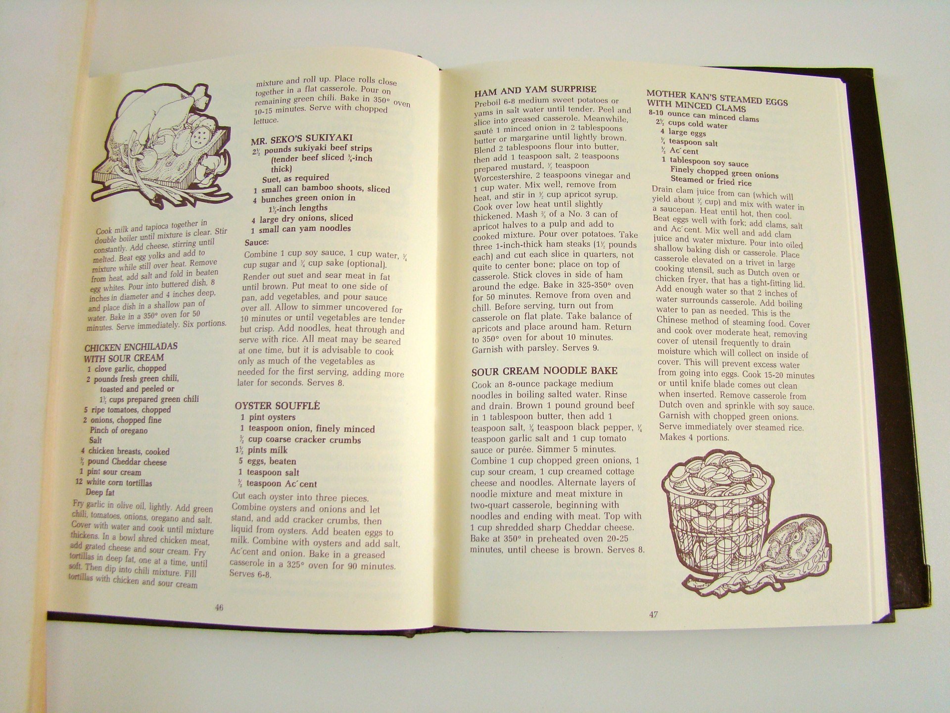 Open recipe book showing recipes for ham and yam surprise, mother kan's steamed eggs with minced clams, chicken enchiladas with sour cream, oyster soufflé, and sour cream noodle bake, with illustrations of a ham and yam dish and a bowl of noodles.
