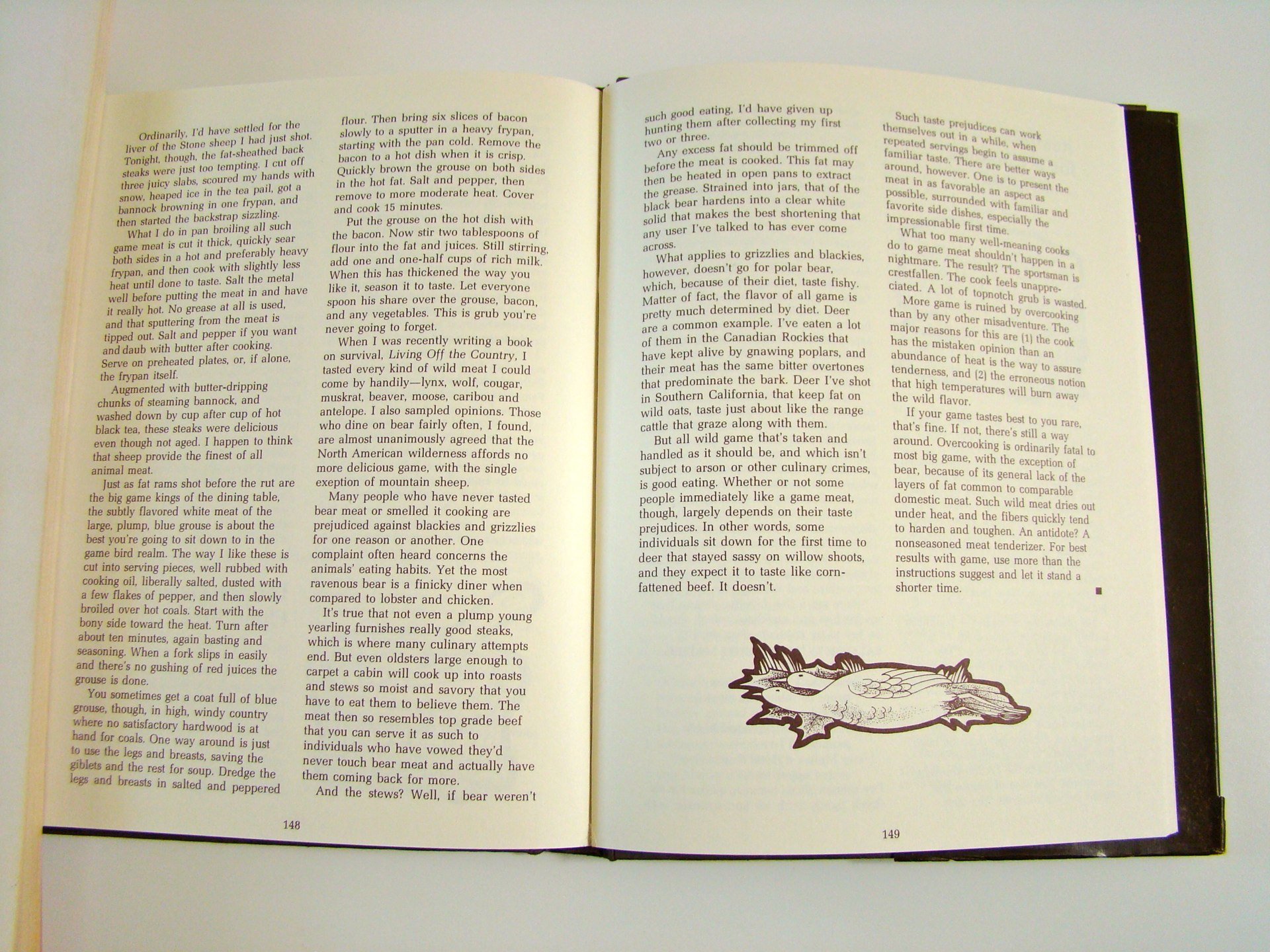 Open book on a white surface, showing pages 148 and 149 with text and a small illustration of a fish at the bottom of page 149.