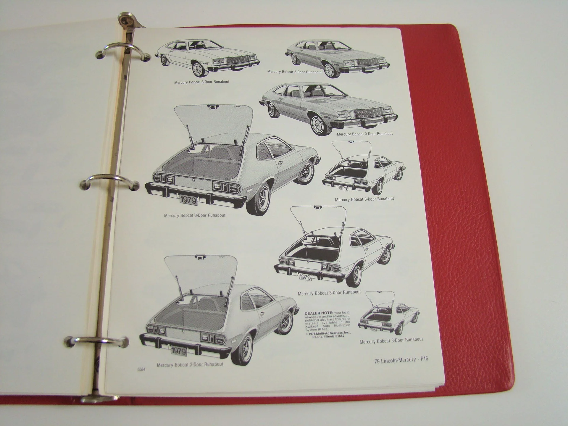 Page with black and white illustrations of a 1979 Mercury Bobcat 3-door, showing multiple angles and details, in a binder with a red cover.